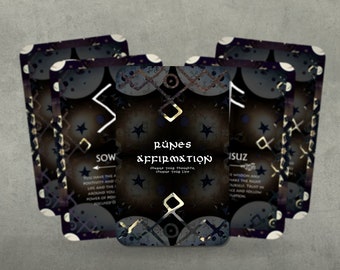 May include: A set of cards with black and gold runes and affirmations. The cards have a dark background with a pattern of stars and circles. The text on the cards reads "Runes Affirmation, Change your thoughts, change your life."