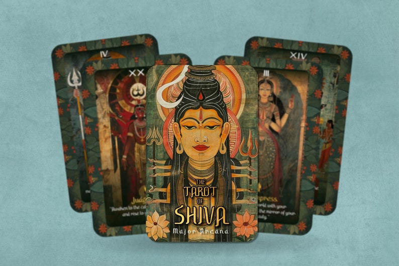 May include: A tarot deck with a green, orange, and gold design. The card in the center is the "The Tarot of Shiva" card, which features a colorful illustration of Shiva. The card is surrounded by other cards from the deck, including the "Judgement" card, the "Empress" card, and the "XIV" card.