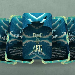May include: A set of oracle cards with a blue and green watercolor background. The cards feature a variety of images and text, including "The Rainbow", "The Miracle", "Noah and the Ark", "The Dove", and "The Animals' Song".