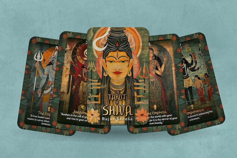 May include: A set of tarot cards with colorful illustrations of Hindu deities. The cards are arranged in a semi-circle with the card titled "The Tarot of Shiva" in the center. The text on the cards reads "The Emp, Judgement, The Empress, Temperance".