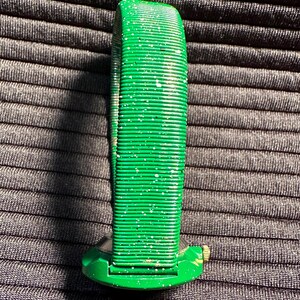 May include: A green watch with a sparkly green band. The watch face is round and has a gold accent.