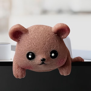 May include: A set of three ceramic mugs with a speckled, matte finish. The mugs are in shades of cream, light gray, and dark gray. Each mug has a simple, minimalist design, perfect for coffee or tea.