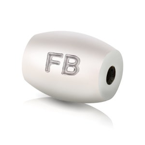 May include: White oval bead with the letters "FB" engraved on the side.