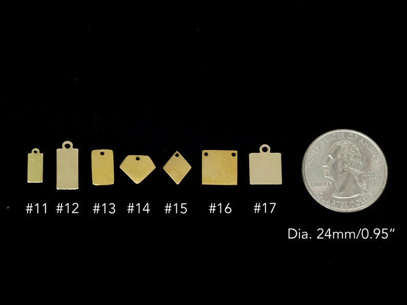 May include: Seven different sizes of brass metal tags with rounded corners and a hole at the top. The tags are arranged in a row from smallest to largest. A US quarter is shown for size comparison. The quarter measures 24mm or 0.95 inches in diameter.