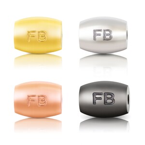 May include: Four metal beads with the letters "FB" engraved on them. The beads are in four different colours: gold, silver, rose gold, and black.