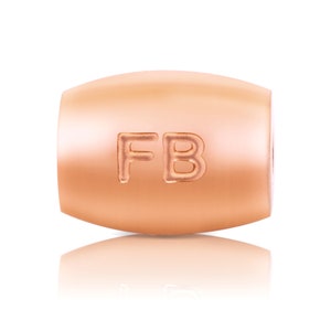 May include: A rose gold charm bead with the letters "FB" engraved on it.