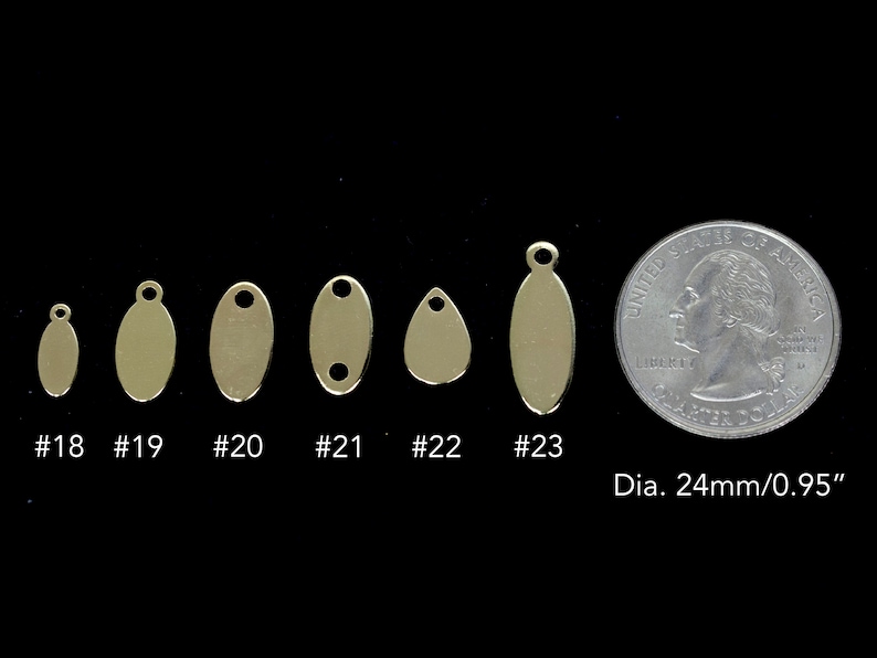 May include: Six different sizes of gold oval metal tags with a hole at the top for hanging. The tags are arranged in order of size from smallest to largest. The smallest tag is about the size of a dime. The largest tag is about the size of a quarter. A U.S. quarter is shown for size comparison. The text "Dia. 24mm/0.95" is also shown.