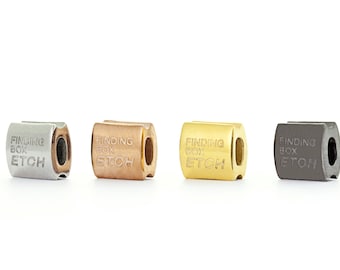 May include: Four Finding Box Etch charms in different metal finishes: silver, rose gold, gold, and black.