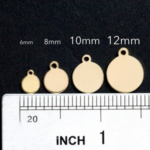 May include: Four gold-colored metal circle charms with a loop at the top. The charms are 6mm, 8mm, 10mm, and 12mm in diameter. A ruler is shown for size reference.