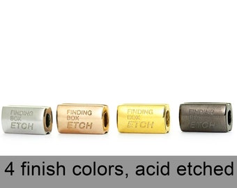 May include: Four metal beads with the words "FINDING BOX ETCH" engraved on each. The beads are silver, rose gold, gold, and black.