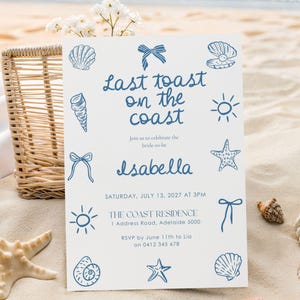 May include: A white invitation card with blue seashell and bow illustrations. The text reads "Last toast on the coast" and invites guests to celebrate Isabella's bridal event. The date is July 13, 2027.