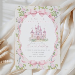 May include: A rectangular invitation card featuring a watercolour illustration of a pink castle centred within an oval frame formed by a pink ribbon and rose vines. The text reads: ONE-CE upon a time, please join us to celebrate Mia's 1st Birthday.