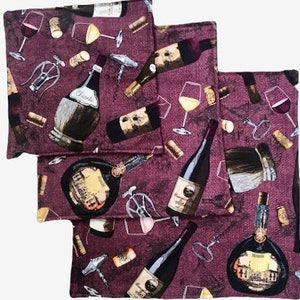 May include: Set of three square wine-themed fabric napkins. The napkins feature a burgundy background with illustrations of wine bottles, glasses, corkscrews, and corks. The design includes various wine bottle labels.