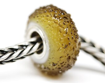 May include: A round, brown glass bead with a textured surface. The bead has a hole in the center for threading onto a bracelet or necklace.