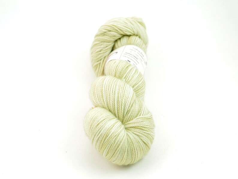 May include: A skein of light green yarn with a white label.