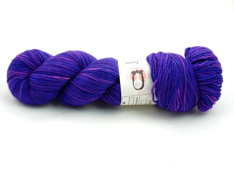 May include: A skein of purple and pink hand-dyed yarn with a white label that reads "Fair Isle".