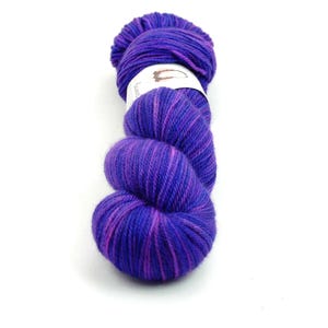 May include: A skein of purple and pink yarn with a white label that says "Lace".