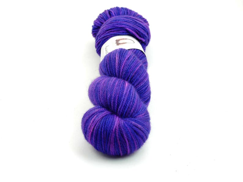May include: A skein of purple and pink yarn with a white label that says "Lace".