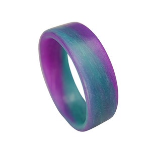 May include: A purple and teal silicone ring with a marbled pattern.