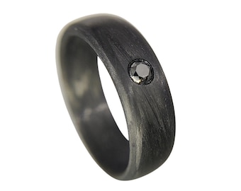 May include: A black carbon fiber ring with a single black diamond set in the center.