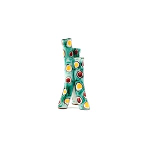 May include: A ceramic vase with three stems, painted in teal with yellow and maroon polka dots. The vase has a glossy finish and is set against a white background. The vase is a decorative item.