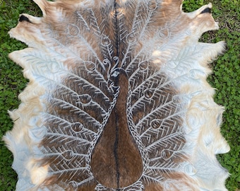 Hand carved goatskins - peacock design.