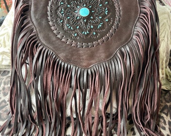 Tan leather fringed bag with stone center