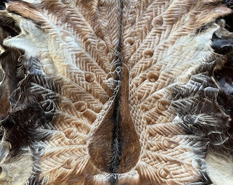 Hand carved goatskins - peacock design.