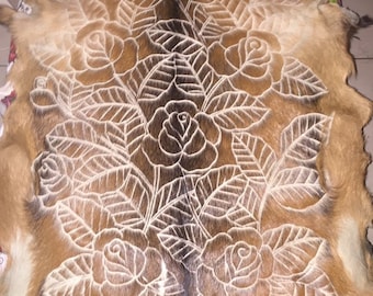Rose design. Handcarved goat skin.
