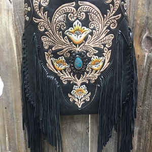 Black leather fringe bag.