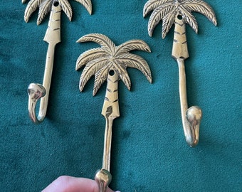 Brass hooks. Palm trees.