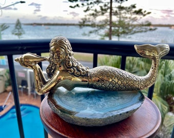 Brass mermaid. Holding a shell