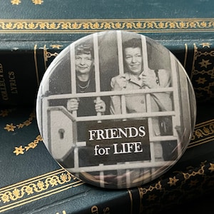 May include: Black and white photo of two women behind bars with the text "FRIENDS for LIFE".