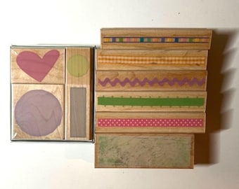 May include: A collection of wooden stamps with various designs. The stamps include shapes like a heart and circle, and decorative border patterns in colors like pink, green, and purple. The stamps are ideal for crafting and scrapbooking.