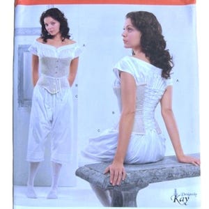 May include: A white ceramic mug with a black handle and the text "But First, Coffee" in a black, bold font. The mug is on a white surface. The mug is approximately 4 inches tall.