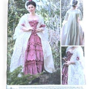 May include: Simplicity sewing pattern 8578 for an American Duchess 18th-century gown. The pattern features a woman in a pink and white dress with a ruffled skirt and lace trim. The pattern includes size options.