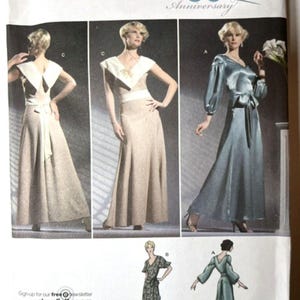 May include: A Simplicity 3619 sewing pattern envelope featuring illustrations of floor-length dresses. The designs include a beige dress with a white collar and sash, and a blue dress with long sleeves and a tie waist. Text includes 80th Anniversary.