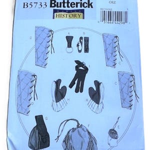 May include: A Butterick sewing pattern, B5733, featuring illustrations of historical costume accessories. The pattern includes designs for gloves, pouches, and leg coverings, with detailed diagrams and instructions. The pattern is printed on a light blue background.