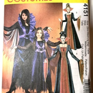 May include: A McCall's Costumes sewing pattern envelope 4151 featuring illustrations of two gown styles. Style A shows a purple and black dress with a high ruffled collar and spider motif. Style B shows a black and rust-colored gown with a high collar.