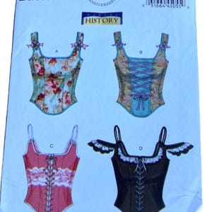 May include: A Butterick sewing pattern, B5935, featuring four corset designs. The pattern includes a floral print, a design with a lace-up front, and a black corset with decorative trim. The pattern celebrates the 150th anniversary.