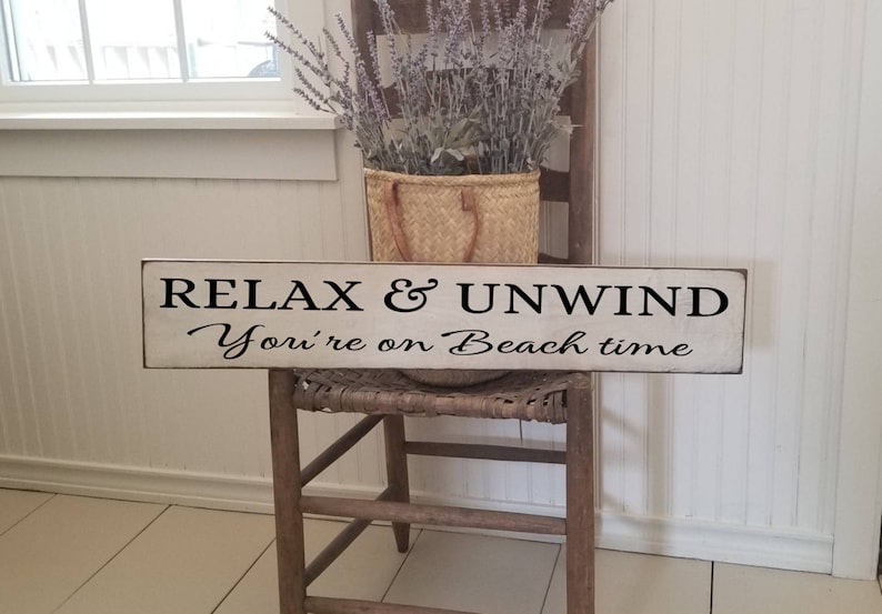 Peut inclure: Une pancarte en bois blanc avec du texte noir qui dit "Relax & Unwind You're on Beach time".