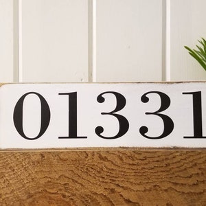 May include: White wooden sign with black painted numbers "01331".