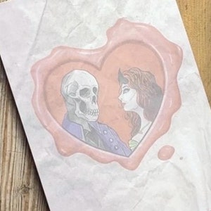 May include: A pink heart-shaped wax seal with a skeleton and a woman looking at each other inside. The background is white textured paper.