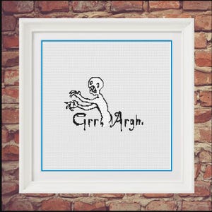 May include: Black and white cross-stitch pattern of a cartoon monster with the text "Grrr, Argh."