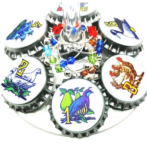 May include: Twelve Days of Christmas themed bottle charms with silver beads and colorful glass beads. Each charm features a different image from the song, including a partridge in a pear tree, two turtle doves, and three French hens.
