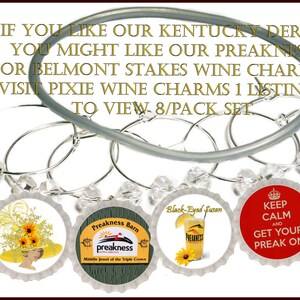 May include: Set of eight silver wine glass charms with colorful Preakness-themed bottle cap designs. The designs include a horse and rider, sunflowers, and the text "Preakness Party", "Preakness Barn", "Black-Eyed Susan", and "Keep Calm and Get Your Preak On".