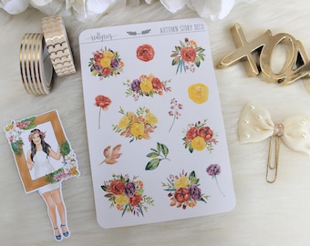 May include: A sheet of stickers with an autumn theme. The stickers feature floral bouquets in shades of yellow, orange, red, and purple. The text "AUTUMN STORY DECO" is printed at the top of the sheet.