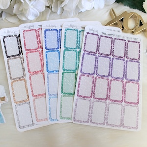 May include: Five sheets of glitter sticker paper with different colored borders. The borders are black, pink, blue, green, and purple. Each sheet has 10 rectangular stickers.