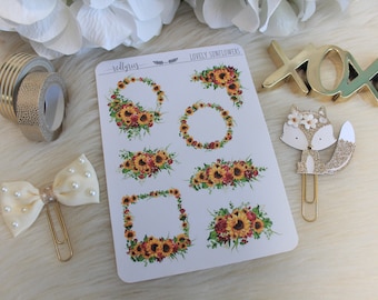 May include: A sheet of stickers featuring watercolor illustrations of sunflower wreaths and bouquets. The stickers are on a white background and have the text "Lovely Sunflowers" printed on the top.