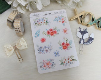 May include: A sheet of floral field-themed stickers with various watercolor floral designs in shades of pink, blue, and green. The stickers are on a white background and have the text "rollygrus" and "FLORAL FIELD-DECO" printed on the sheet.